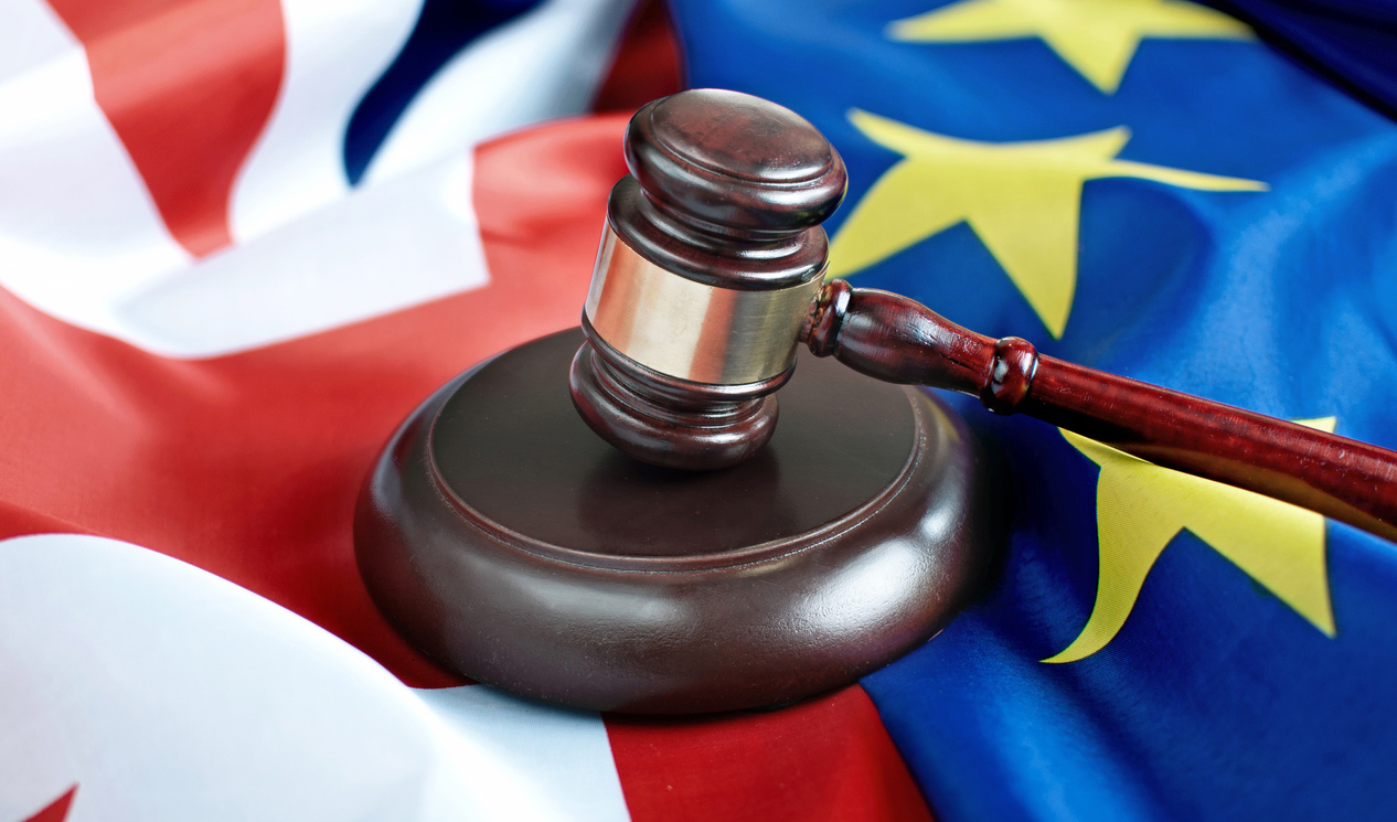 Gavel on top of British and European flags
